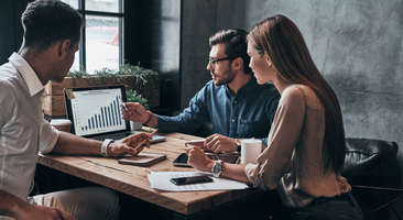 three business people attend a meeting on the East Coast